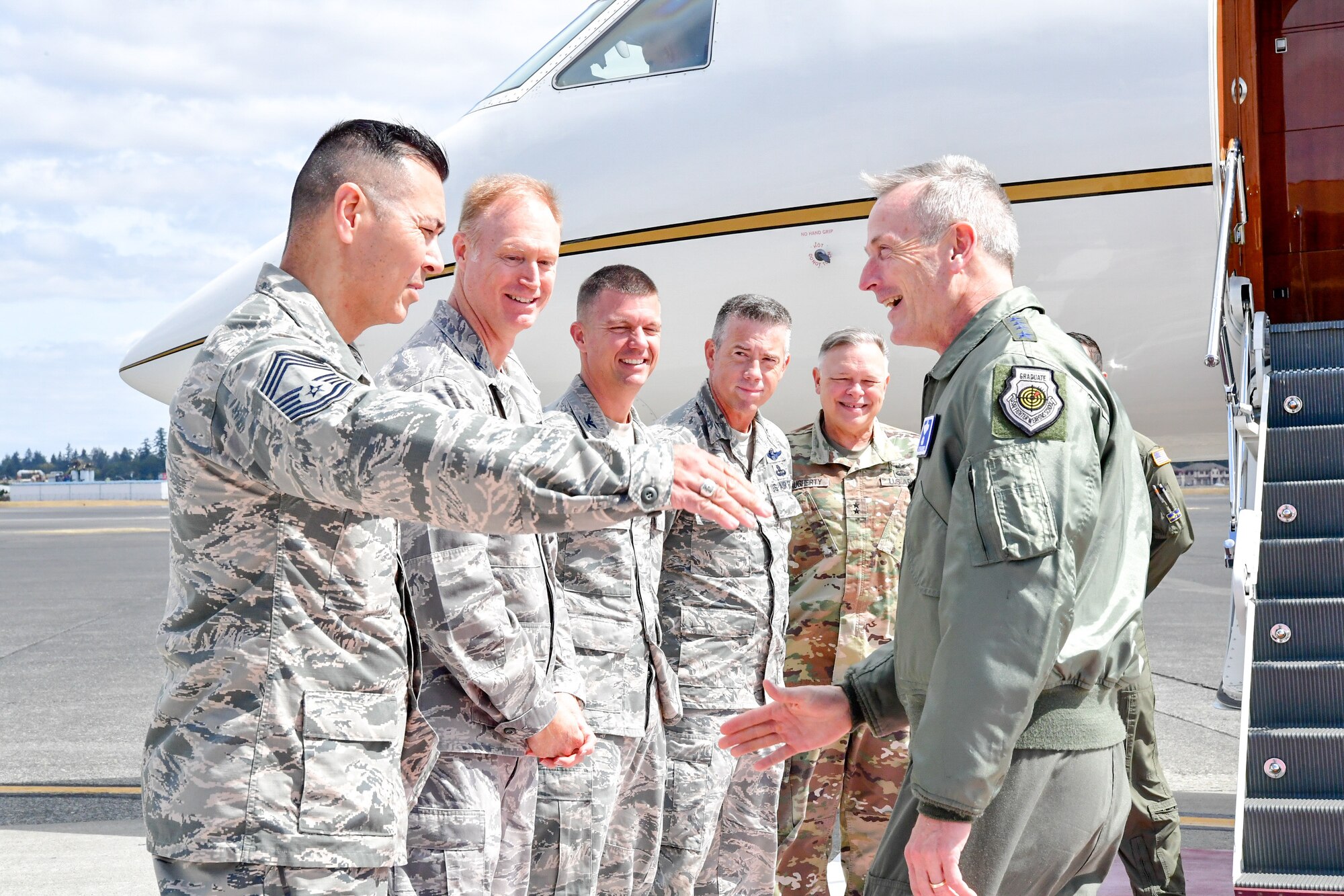 Chief Master Sgt. Allan Lawson, Western Air Defense Sector Senior Enlisted Leader, greets Gen. Terrence O'Shaughnessy, NORAD and USNORTHCOM commander, as he arrives to Joint Base Lewis-McChord, Washington Aug. 23, 2018.  O'Shaughnessy met with the Western Air Defense Sector operations crew that provided command and control of the 142nd Fighter Wing's F-15 intercept of the Aug. 10 stolen Horizon Bombardier Q400 aircraft out of SeaTac International Airport.  Also pictured from left to right are Col. Gregory Lewis, WADS commander, Col. Scovill Currin, 62nd Airlift Wing Commander,  Brig. Gen. Jeremy Horn, Washington Air National Guard Commander, and Maj. Gen. Bret Daugherty, The Adjutant General, Washington. (U.S. Air National Guard photo by Maj. Kimberly D. Burke)