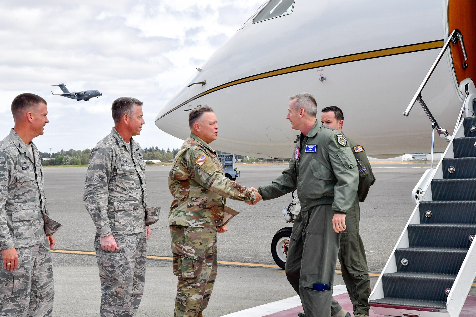 Maj. Gen. Bret Daughterty, The Adjutant General for Washington, greets Gen. Terrence O'Shaughnessy, NORAD and USNORTHCOM commander, as he arrives to Joint Base Lewis-McChord, Washington Aug. 23, 2018.  O'Shaughnessy met with the Western Air Defense Sector operations crew that provided command and control of the 142nd Fighter Wing's F-15 intercept of the Aug. 10 stolen Horizon Bombardier Q400 aircraft out of SeaTac International Airport.  Also pictured are Brig. Gen. Jeremy Horn, Washington Air National Guard Commander (second from left) and Col. Scovill Currin, 62nd Airlift Wing Commander (left).  (U.S. Air National Guard photo by Maj. Kimberly D. Burke)
