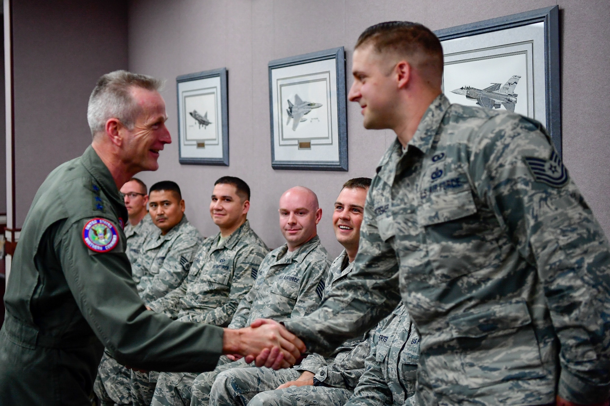 Gen. Terrence O'Shaughnessy, NORAD and USNORTHCOM commander, recognizes Tech. Sgt. Aaron DeCremer, 225th Air Defense Squadron weapons director, with a commander’s coin for the critical role he played during the Aug. 10, 2018 F-15 fighter intercept of the stolen Horizon Bombardier Q400 aircraft out of SeaTac International Airport.  O'Shaughnessy visited the WADS Aug. 23 in order to commend the WADS operations crew for their expert command and control of the 142nd Fighter Wing's F-15 intercept of the stolen aircraft. (U.S. Air National Guard photo by Maj. Kimberly D. Burke)