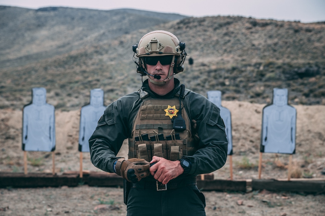 A police officer with the Carson City Special Weapons and Tactics (SWAT) team loads a magazine before conducting the Marine Corps Pistol Qualification at a training area in Hawthorne, Nev., Aug 2, 2018. The purpose of this training was for Marine Corps Forces Special Operations Command Marines and Carson City SWAT to exchange knowledge and tactics to improve not only the Marines’ war fighting lethality, but also for the SWAT team to improve their tactics for specialized domestic incidents. (U.S. Marine Corps photo by Lance Cpl. William Chockey)