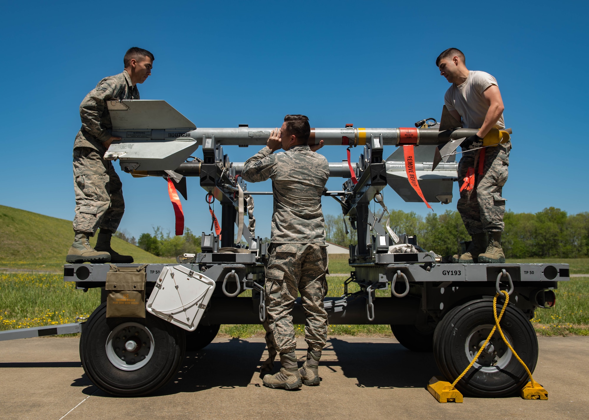 U.S. Air Force Airmen from the 1st Maintenance Squadron precision guided munitions unit, mount an AIM-9 Sidewinder missile at Joint Base Langley-Eustis, Virginia, April 30, 2018.