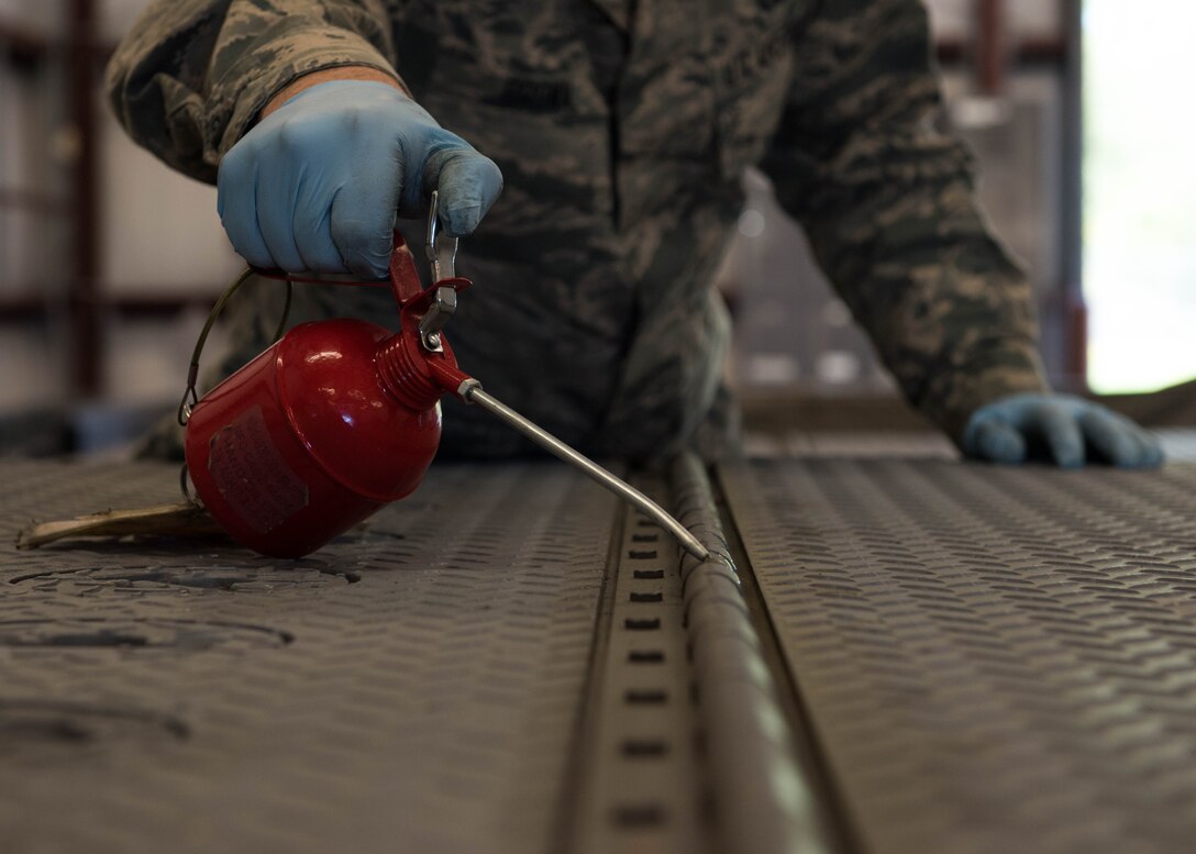 U.S. Air Force Airman 1st Class Dakota Brown, 1st Maintenance Squadron equipment maintenance technician lubricates a trailer for maintenance at Joint Base Langley-Eustis, Virginia, April 30, 2018.