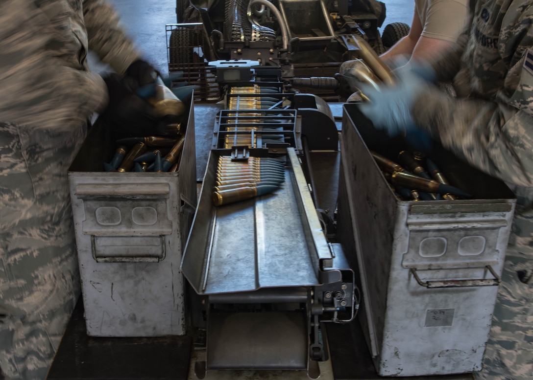 U.S. Air Force Airmen from the 1st Maintenance Squadron conventional unit, load 20 mm rounds on to a universal ammunition loading system at Joint Base Langley-Eustis, Virginia, May 1, 2018.