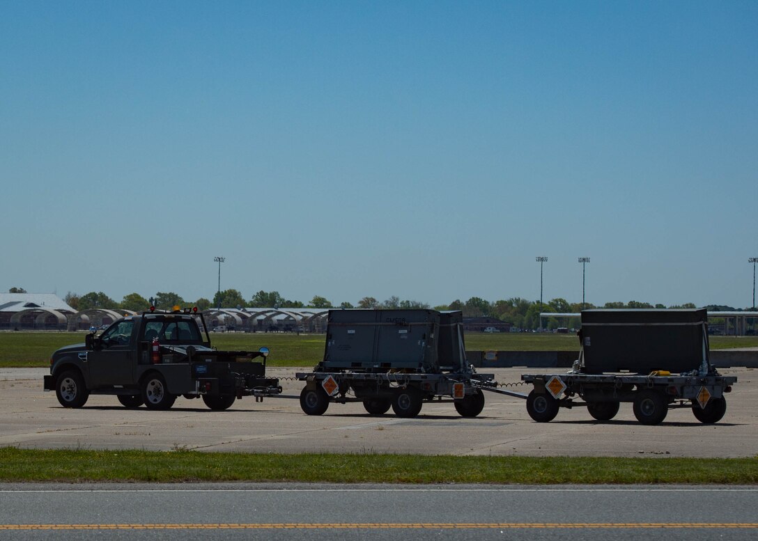 U.S. Air Force Airmen from the 1st Maintenance Squadron line delivery unit, bring trailers loaded with chaff to the flightline at Joint Base Langley-Eustis, Virginia, May 1, 2018.