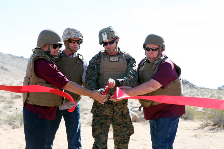 BGen Roger B. Turner Jr., Combat Center Commanding General, cuts the ribbon before the start of the live-fire training exercise conducted in the Galway Lake Training Area in the Johnson Valley Exclusive Military Use Area, Marine Corps Air Ground Combat Center, Twentynine Palms, Calif., Aug. 24, 2018. (Marine Corps photo by Kelly O'Sullivan)