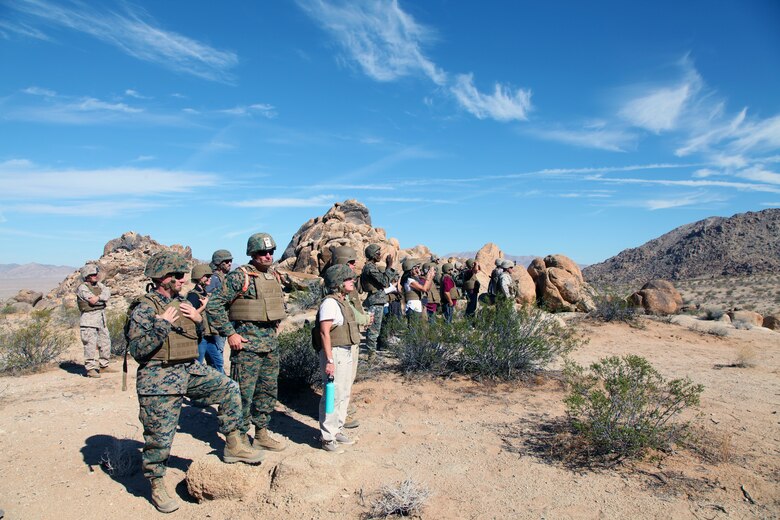 BGen Roger B. Turner, second from left, and guests watch as members India Company, India Company, 3rd Battalion, 4th Marines, 7th Marine Regiment, work their way toward their first objective during live-fire training in the Galway Lake Training Area in the Johnson Valley Exclusive Military Use Area, Marine Corps Air Ground Combat Center, Twentynine Palms, Calif., Aug. 24, 2018. (Marine Corps photo by Kelly O'Sullivan)