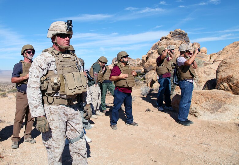 LtCol Jimmy Birchfield, Commanding Officer, 3rd Battalion, 4th Marines, 7th Marine Regiment, and guests watch as members of India Company conduct live-fire training in the Galway Lake Training Area in the Johnson Valley Exclusive Military Use Area, Marine Corps Air Ground Combat Center, Twentynine Palms, Calif., Aug. 24, 2018. (Marine Corps photo by Kelly O'Sullivan)