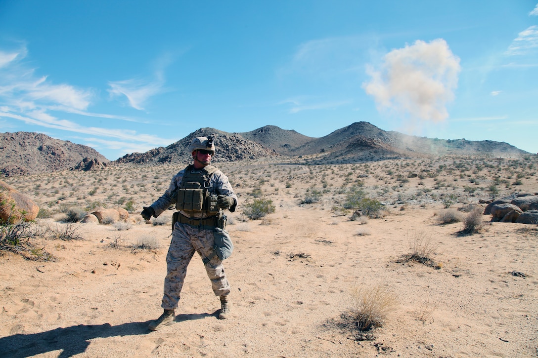 LtCol Jimmy Birchfield, Commanding Officer, 3rd Battalion, 4th Marines, 7th Marine Regiment, describes what’s happening behind him as members of India Company conduct live-fire training in the Galway Lake Training Area in the Johnson Valley Exclusive Military Use Area, Marine Corps Air Ground Combat Center, Twentynine Palms, Calif., Aug. 24, 2018. (Marine Corps photo by Kelly O'Sullivan)