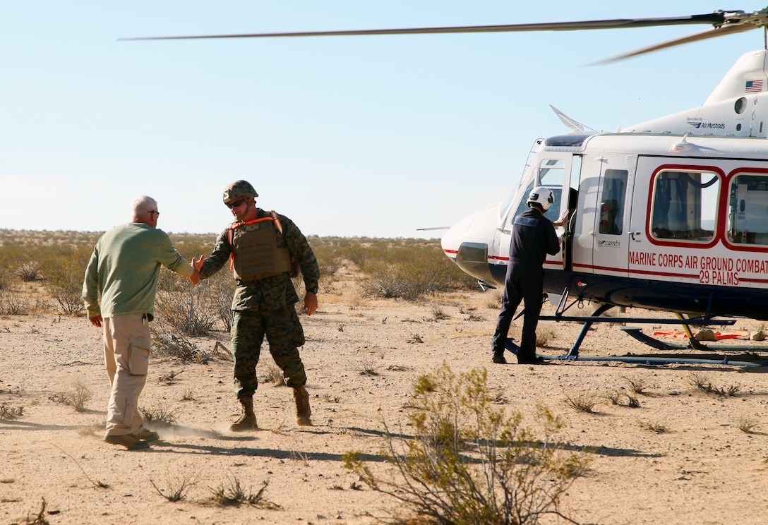 Jim Ricker, Director, Government and External Affairs, Marine Corps Air Ground Combat Center, Twentynine Palms, Calif., greets BGen Roger B. Turner Jr., Combat Center Commanding General, as Turner arrives in the Galway Lake Training Area in the Johnson Valley Exclusive Military Use Area, Aug. 24, 2018, to talk with VIP guests from the surrounding communities on hand to watch live-fire training conducted by India Company, 3rd Battalion, 4th Marines, 7th Marine Regiment, in the Exclusive Military Use Area. (Marine Corps photo by Kelly O'Sullivan)