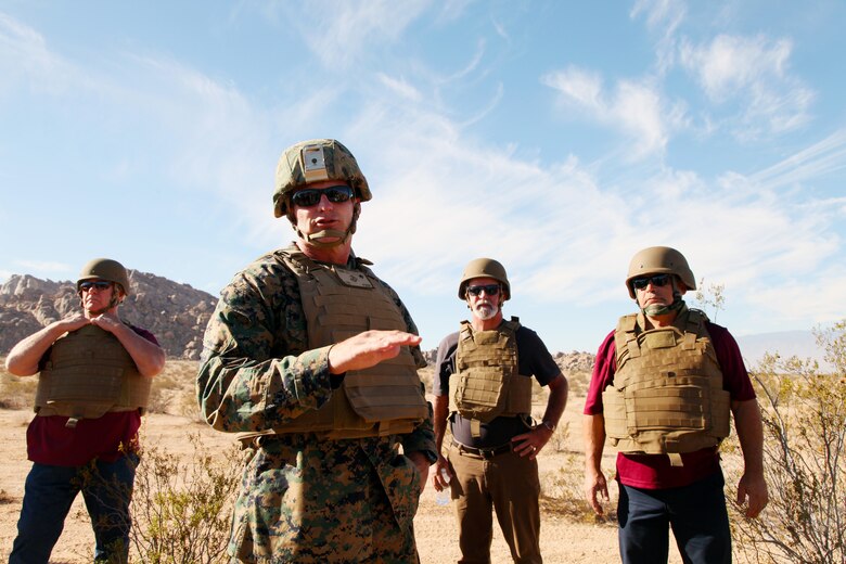 BGen Roger B. Turner Jr., Combat Center Commanding General, talks with VIP guests assembled in the Galway Lake Training Area in the Johnson Valley Exclusive Military Use Area, Marine Corps Air Ground Combat Center, Twentynine Palms, Calif., Aug. 24, 2018, before they watch members of India Company, 3rd Battalion, 4th Marines, 7th Marine Regiment, conduct live-fire training in the Exclusive Military Use Area. (Marine Corps photo by Kelly O'Sullivan)