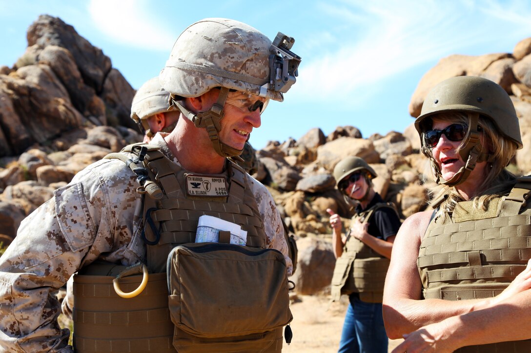 Col. Kyle B. Ellison, Commanding Officer, 7th Marine Regiment, talks with Dawn Rowe, Field Representative for Congressman Paul Cook, during live-fire training conducted by India Company, 3rd Battalion, 4th Marines, 7th Marine Regiment, in the Galway Lake Training Area in the Johnson Valley Exclusive Military Use Area, Marine Corps Air Ground Combat Center, Twentynine Palms, Calif., Aug. 24, 2018. (Marine Corps photo by Kelly O'Sullivan)