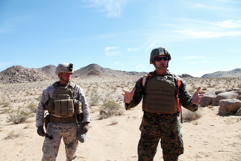 BGen Roger B. Turner, Combat Center Commanding General, right, talks about the importance of training in Johnson Valley after a 40-minute live-fire exercise conducted by India Company, 3rd Battalion, 4th Marines, 7th Marine Regiment, in the Galway Lake Training Area in the Johnson Valley Exclusive Military Use Area, Marine Corps Air Ground Combat Center, Twentynine Palms, Calif., Aug. 24, 2018. With him is LtCol Jimmy Birchfield, Commanding Officer, 3rd Battalion, 4th Marines. (Marine Corps photo by Kelly O'Sullivan)