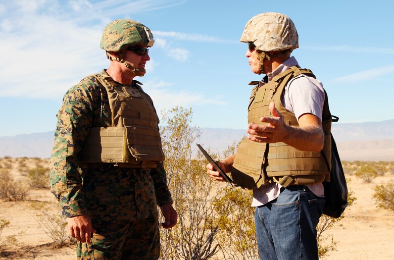 Yucca Valley Mayor Rick Denison, right, presents BGen Roger B. Turner Jr., Combat Center Commanding General, with a certificate of recognition commemorating the live-fire training exercise conducted in the Galway Lake Training Area in the Johnson Valley Exclusive Military Use Area, Marine Corps Air Ground Combat Center, Twenty-nine Palms, Calif., Aug. 24, 2018. (Marine Corps photo by Kelly O'Sullivan)