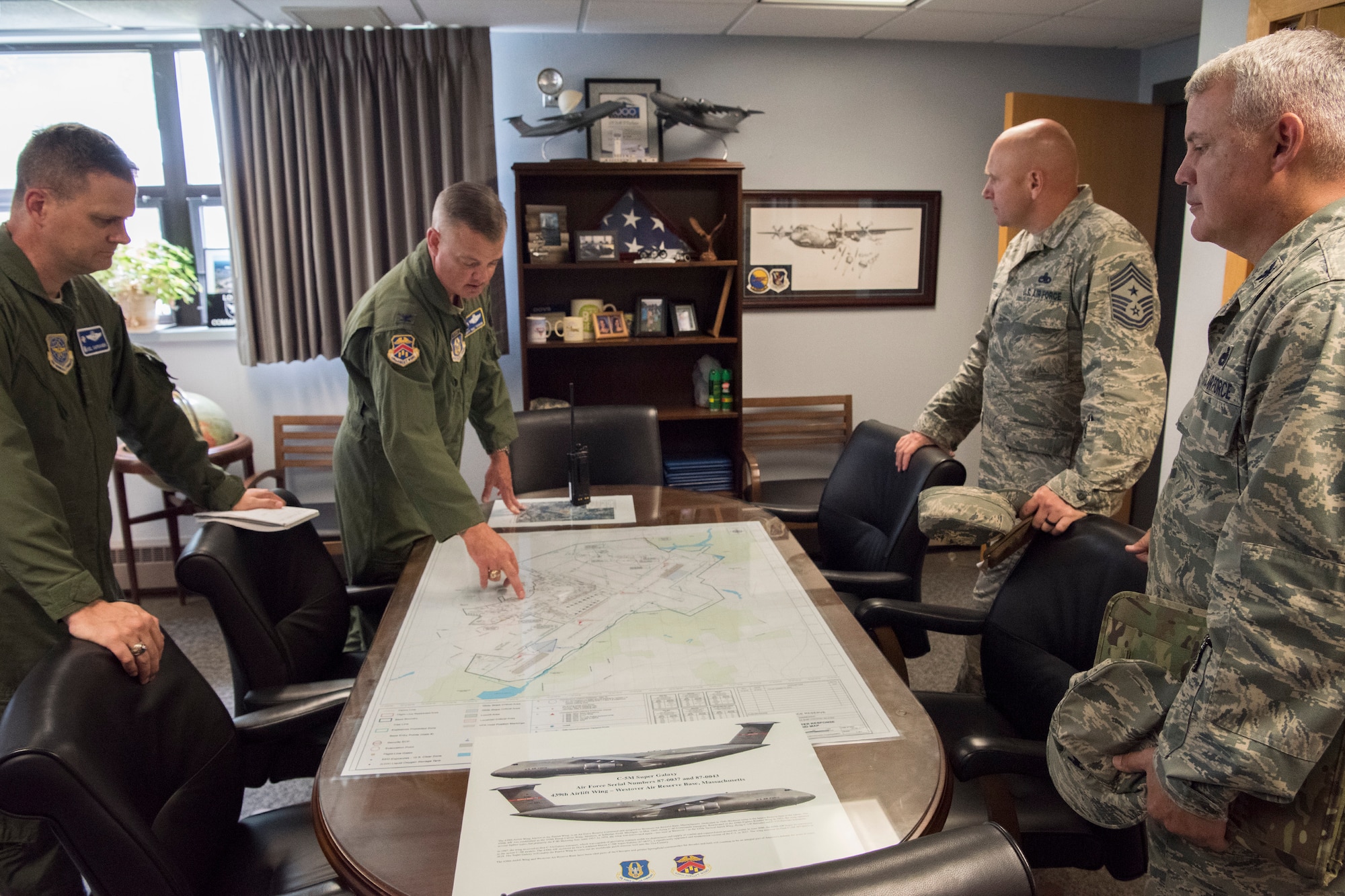 Col. D. Scott Durham, 439th Airlift Wing commander, points out places of interest on an aerial map of Westover Air Reserve Base to 436th Airlift Wing leadership Aug. 22, 2018, at Westover ARB, Mass. Westover is the largest Air Force Reserve base in the United States, employing more than 5,500 military and civilian personnel.  (U.S. Air Force photo by Staff Sgt. Zoe Russell)