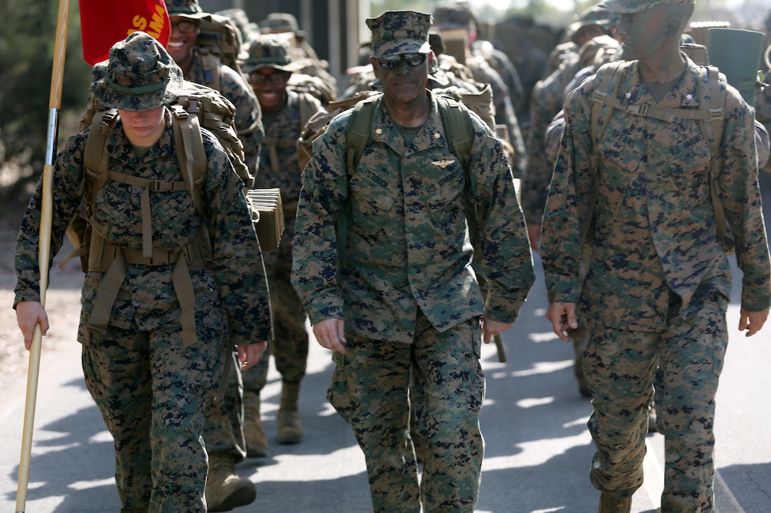 From right to left Lt. Col. Michael A. Spears, commanding officer of Headquarters and Headquarters Squadron, Maj. Robert M. Storck, Executive Officer of H&HS and Sgt. Ashton Reynolds, the H&HS guide, lead Marines with H&HS on a hike from main side Marine Corps Air Station Miramar, Calif., to East Miramar Aug. 24. Following the 4.5 mile hike H&HS held a field mess night to honor the legacy of Marines before them and to build camaraderie in the squadron. (U.S. Marine Corps photo by Cpl. Jake M.T. McClung)