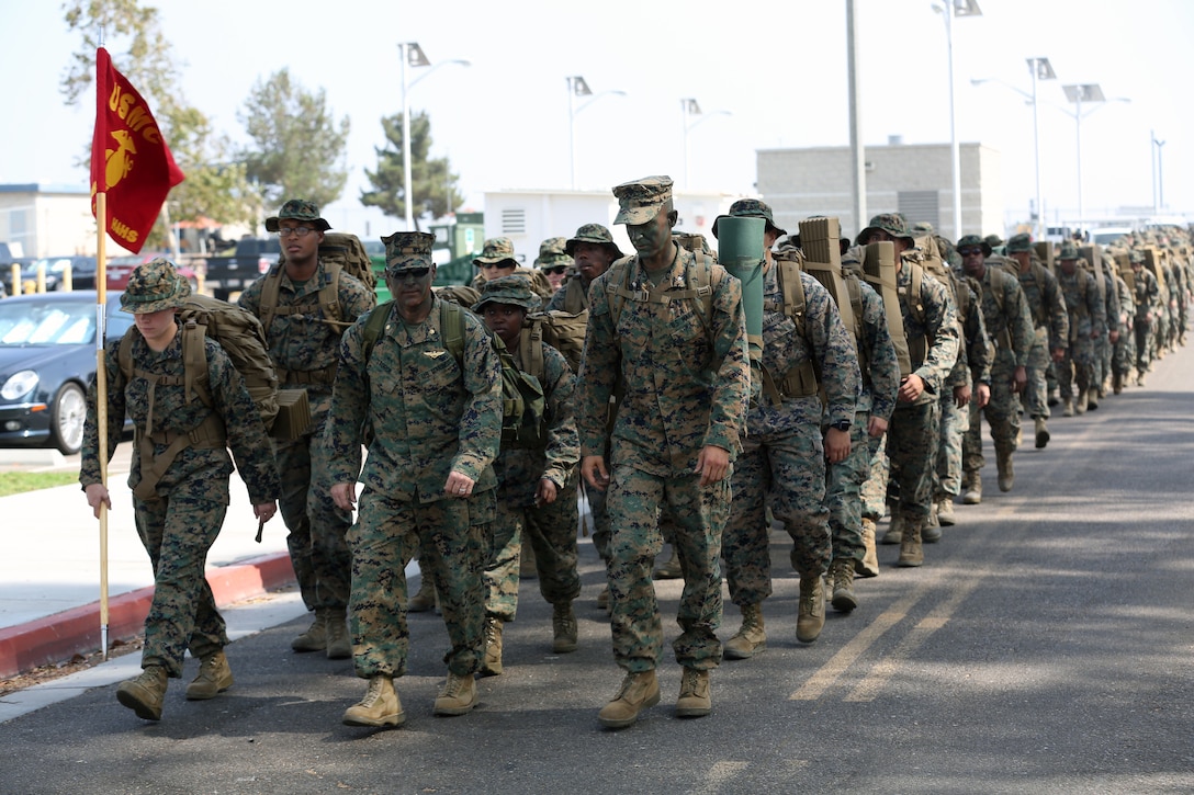Marines and sailors with Headquarters and Headquarters Squadron begin hiking from main side Marine Corps Air Station Miramar, Calif., to East Miramar to hold a field mess night Aug. 24. Following a 4.5 mile hike H&HS held a field mess night to honor the legacy of Marines before them and to build camaraderie in the squadron. (U.S. Marine Corps photo by Cpl. Jake M.T. McClung)