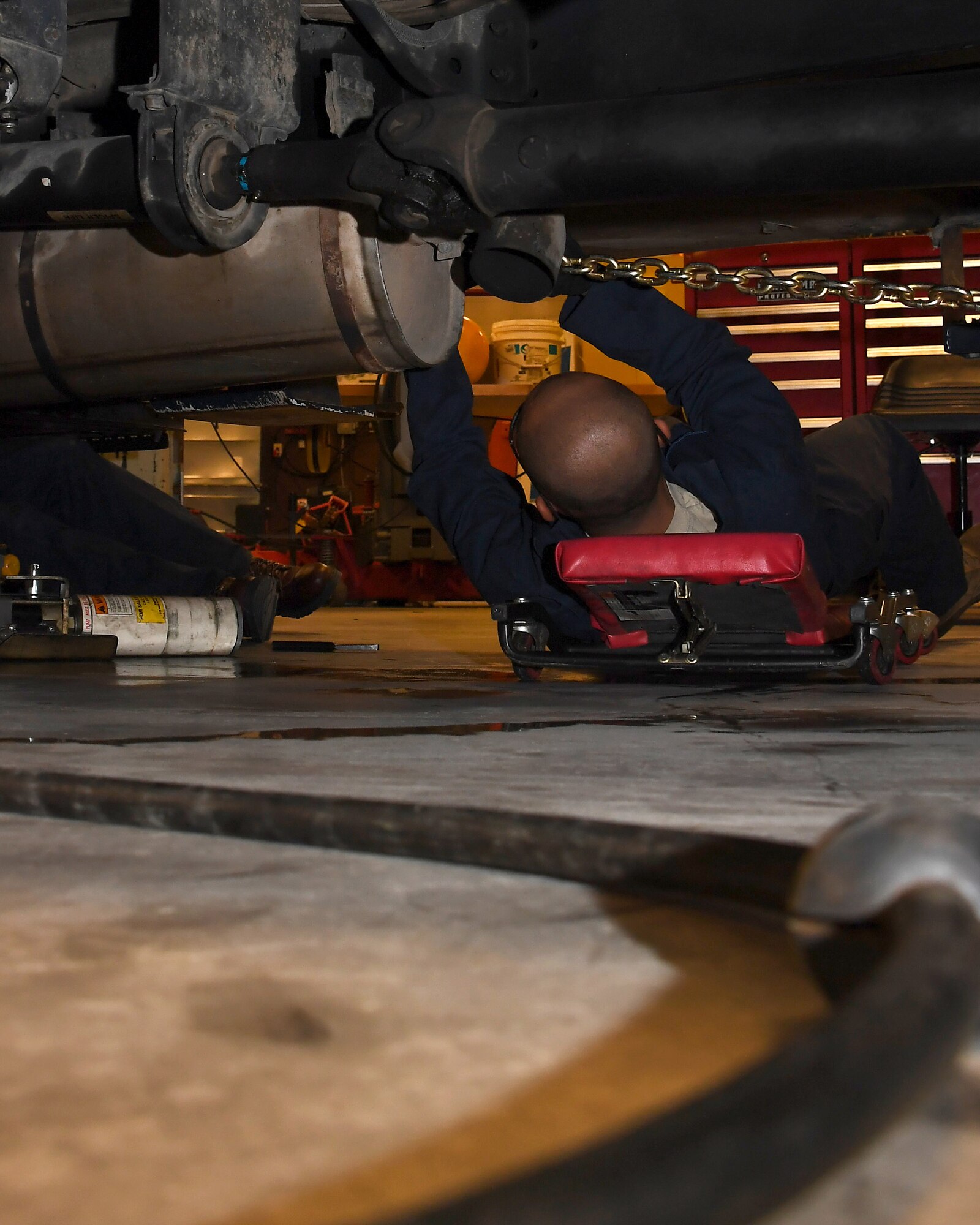 Airman 1st Class Michael Ocaya, 319th Logistics Readiness Squadron fire truck maintenance apprentice, assists with removing a damaged pump from an aerial lift truck August 28, 2018, on Grand Forks Air Force Base, North Dakota. Vehicle maintainers like Ocaya attend technical training of varying lengths depending on which vehicle they are trained on. In Ocaya’s case, as a fire truck maintainer, he was in school for about five months before graduating and being stationed at Grand Forks AFB. (U.S. Air Force photo by Airman 1st Class Elora J. Martinez)