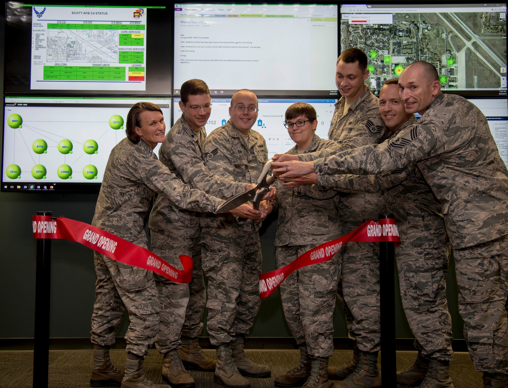 Col. Leslie Maher 375th Air Mobility Wing commander, and the official party cut the ribbon at the grand opening of the Cyber Operations Center, Aug. 23 2018 at Scott Air Force Base, Ill. The CyOC will act as a centralized reporting agency for over 14,000 users on Scott AFB, including it’s vital mission partners.