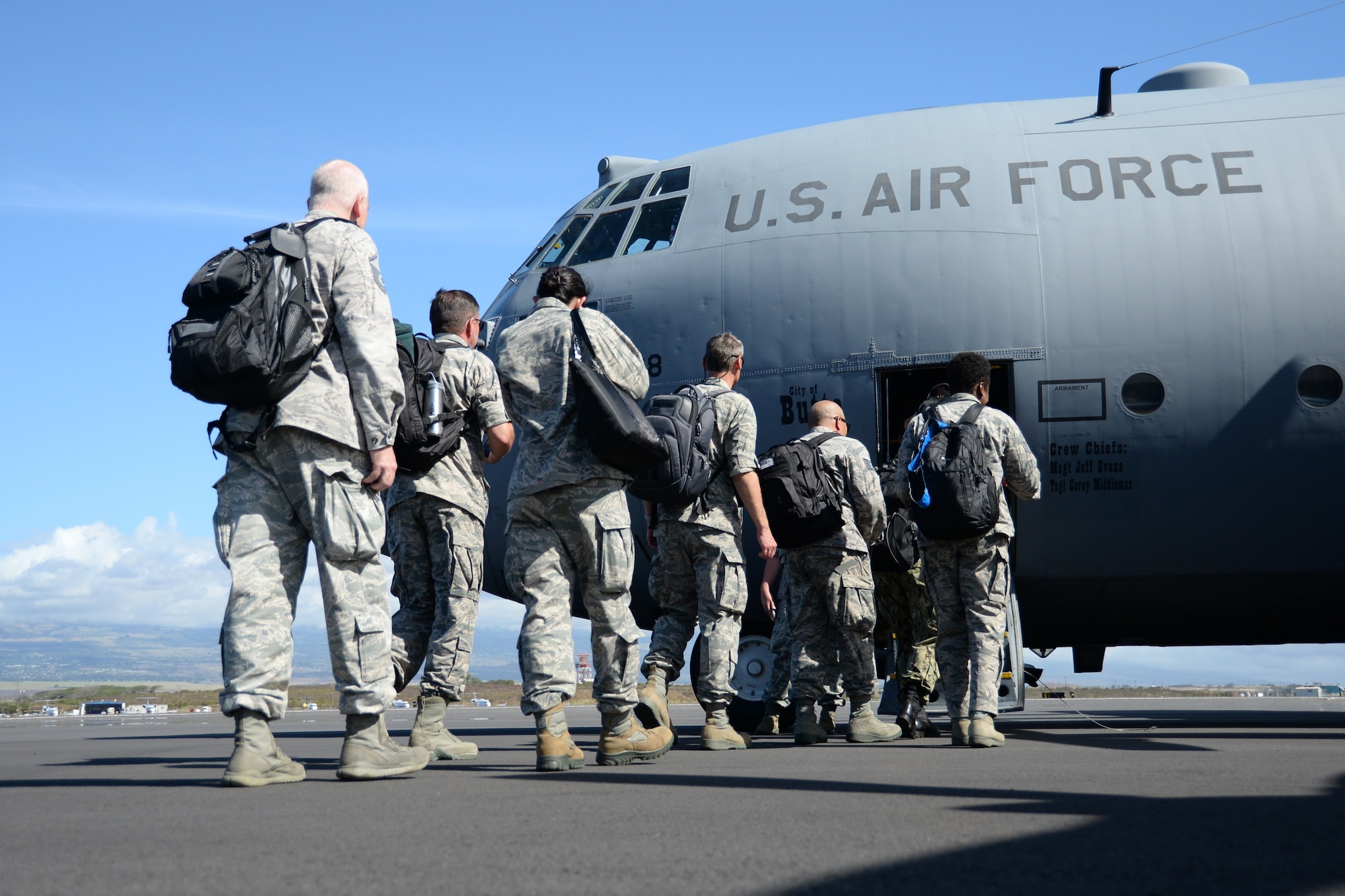 U.S. Air Force Airmen board a C-130 Hercules at Kahului Airport, Hawaii, for airlift to the island of Molokai for Tropic Care Maui County 2018, Hawaii, Aug. 10, 2018. Tropic Care Maui County 2018 is a joint service, hands-on readiness training mission that offered no-cost medical, dental and vision services to people at six locations across Maui, Molokai and Lanai from August 11-19. (U.S Air National Guard photo by Staff Sgt. Kevin Shulze)