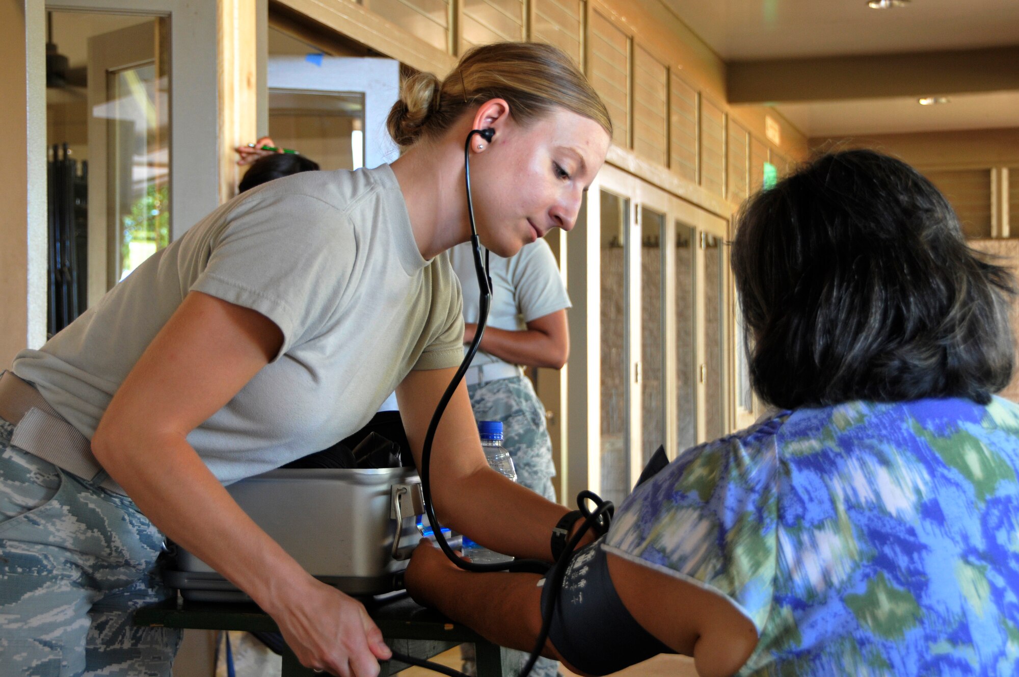 U.S. Air Force Senior Airman Laura Sellers, a medical technician assigned to the 193rd Medical Group, Pennsylvania Air National Guard, takes a community member's blood pressure at the Mitchell Pauole Community Center, Molokai, Hawaii, during Tropic Care Maui County 2018, Aug. 11, 2018. (U.S. Air National Guard photo by Staff Sgt. Lonnie Wiram)