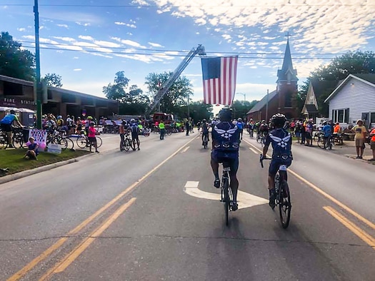 Air Force Cycling Team members ride through a town along the route of the Register's Annual Great Bicycle Ride Across Iowa that took place July 22-28, 2018.