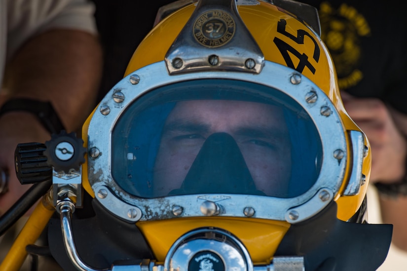 A 511th Engineer Dive Detachment Soldier secures his diving helmet during a dive supervisor qualification training scenario at Joint Base Langley-Eustis, Virginia, Aug. 22, 2018.