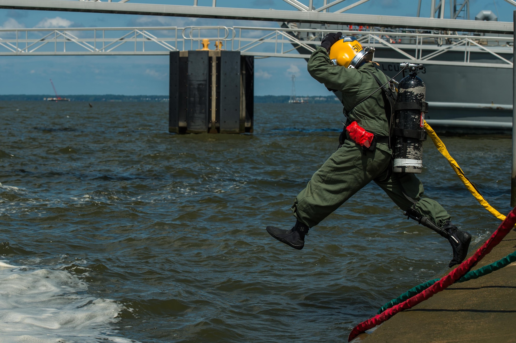 The 511th Engineer Dive Detachment standby diver jumps into the water during a supervisor qualification training scenario at Joint Base Langley-Eustis, Virginia, Aug. 22, 2018.