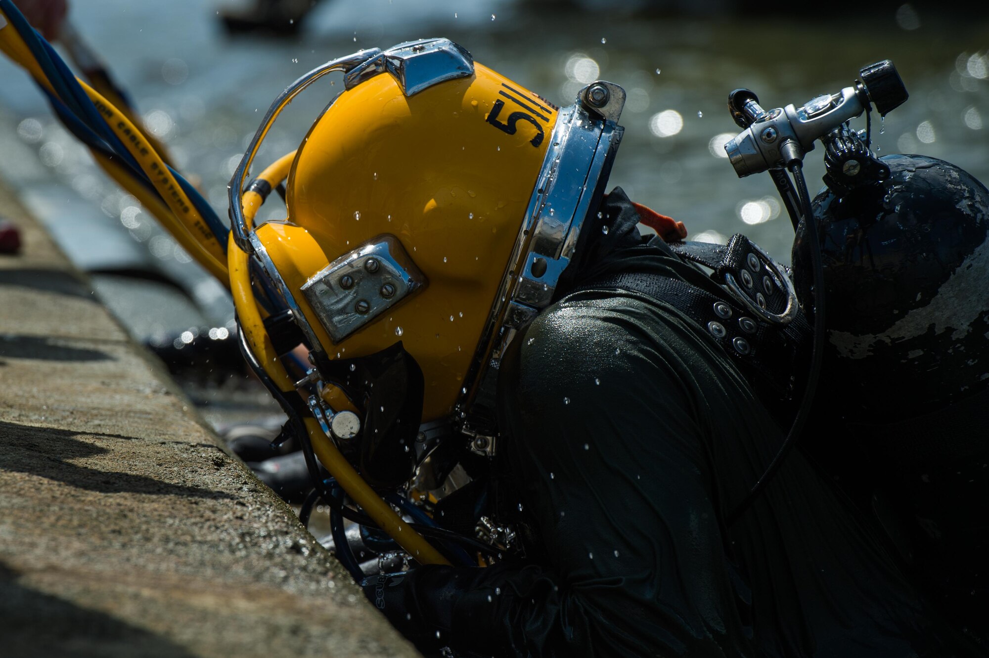 The 511th Engineer Dive Detachment standby diver climbs out of the water during the dive supervisor qualification training scenario at Joint Base Langley-Eustis, Virginia, Aug. 22, 2018.