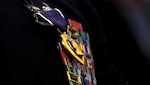 (Former) Chairman of the Joint Chiefs of Staff, Gen. Martin E. Demplsey presents the Purple Heart medal to (then) Tech. Sgt. Richard Chwalik, Dec. 19, 2011 at a town hall meeting during the chairman's visit to Ramstein Air Base, Germany. Chwalik was injured during his deployment to Afghanistan in 2009.