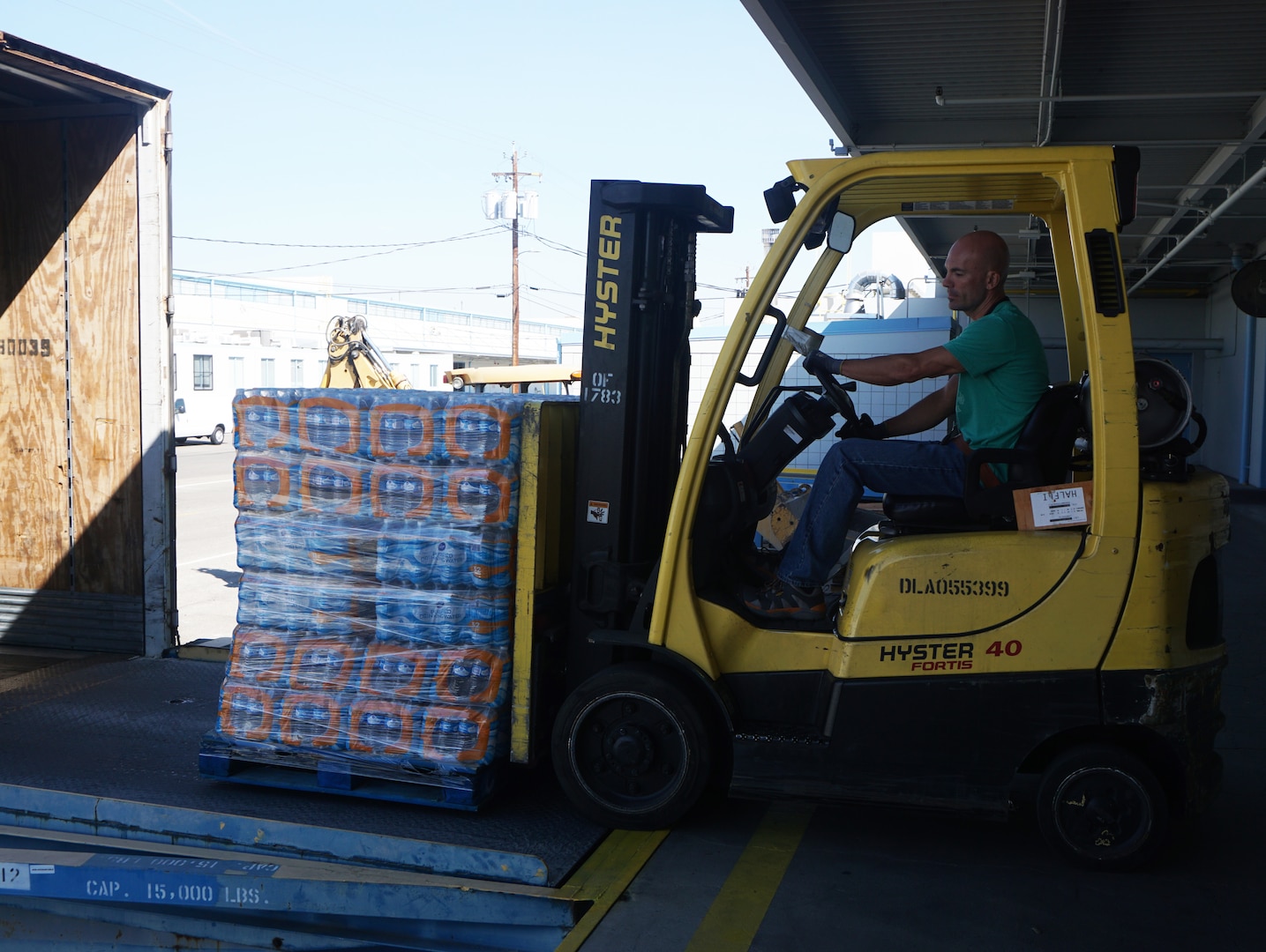 Pictured is Jeffery Edwards of the Bulk Division placing a load of water into the truck to be transported to Travis Air Force Base destined for Hawaii.