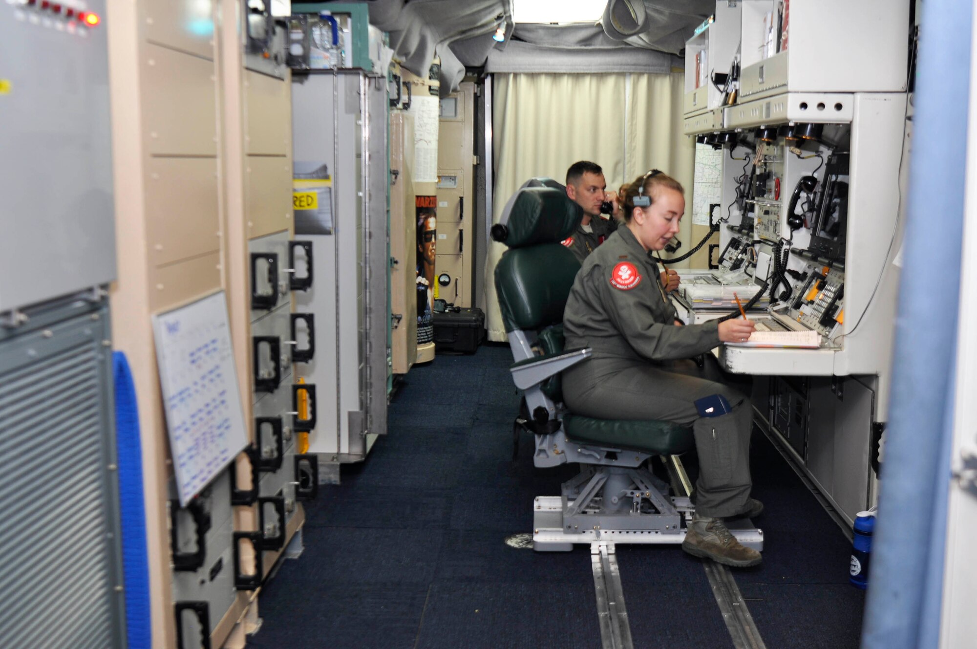 Missileers with the 320th Missile Squadron prepare for a Simulated Electronic Launch-Minuteman test inside a launch control center at a missile alert facility in the 90th Missile Wing missile complex, Aug. 21, 2018. Accomplishing the SELM validates these claims and increases the deterrent capability of the Minuteman III ICBM weapon system. (U.S. Air Force photo by Senior Airman Breanna Carter)