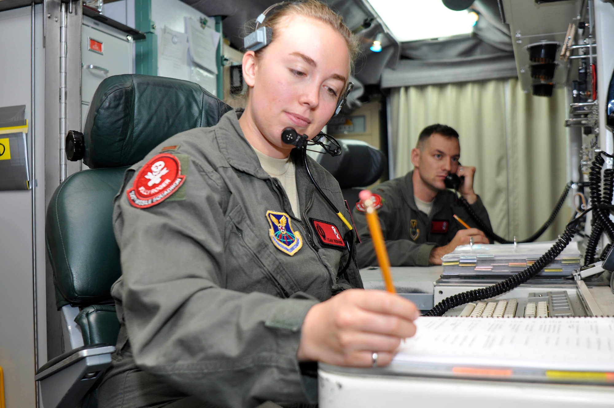 Second Lieutenant Teah Heidorn, 320th Missile Squadron deputy combat crew commander, writes notes during a Simulated Electronic Launch-Minuteman test inside a launch control center at a missile alert facility in the 90th Missile Wing missile complex, Aug. 21, 2018. Accomplishing the SELM validates these claims and increases the deterrent capability of the Minuteman III ICBM weapon system. (U.S. Air Force photo by Senior Airman Breanna Carter)