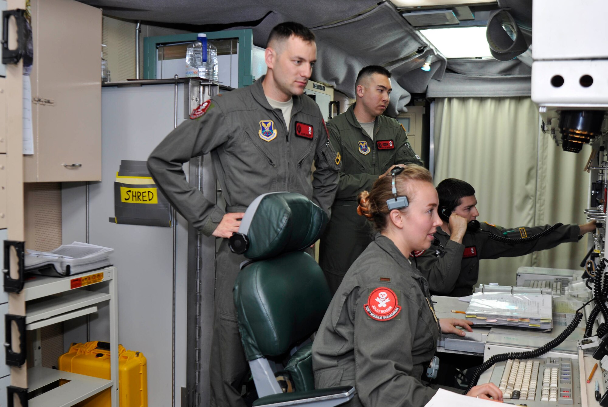 Missileers with the 320th Missile Squadron monitor screens in a launch control center during a Simulated Electronic Launch-Minuteman test at a missile alert facility in the 90th Missile Wing missile complex, Aug. 21, 2018. Accomplishing the SELM validates these claims and increases the deterrent capability of the Minuteman III ICBM weapon system. (U.S. Air Force photo by Senior Airman Breanna Carter)