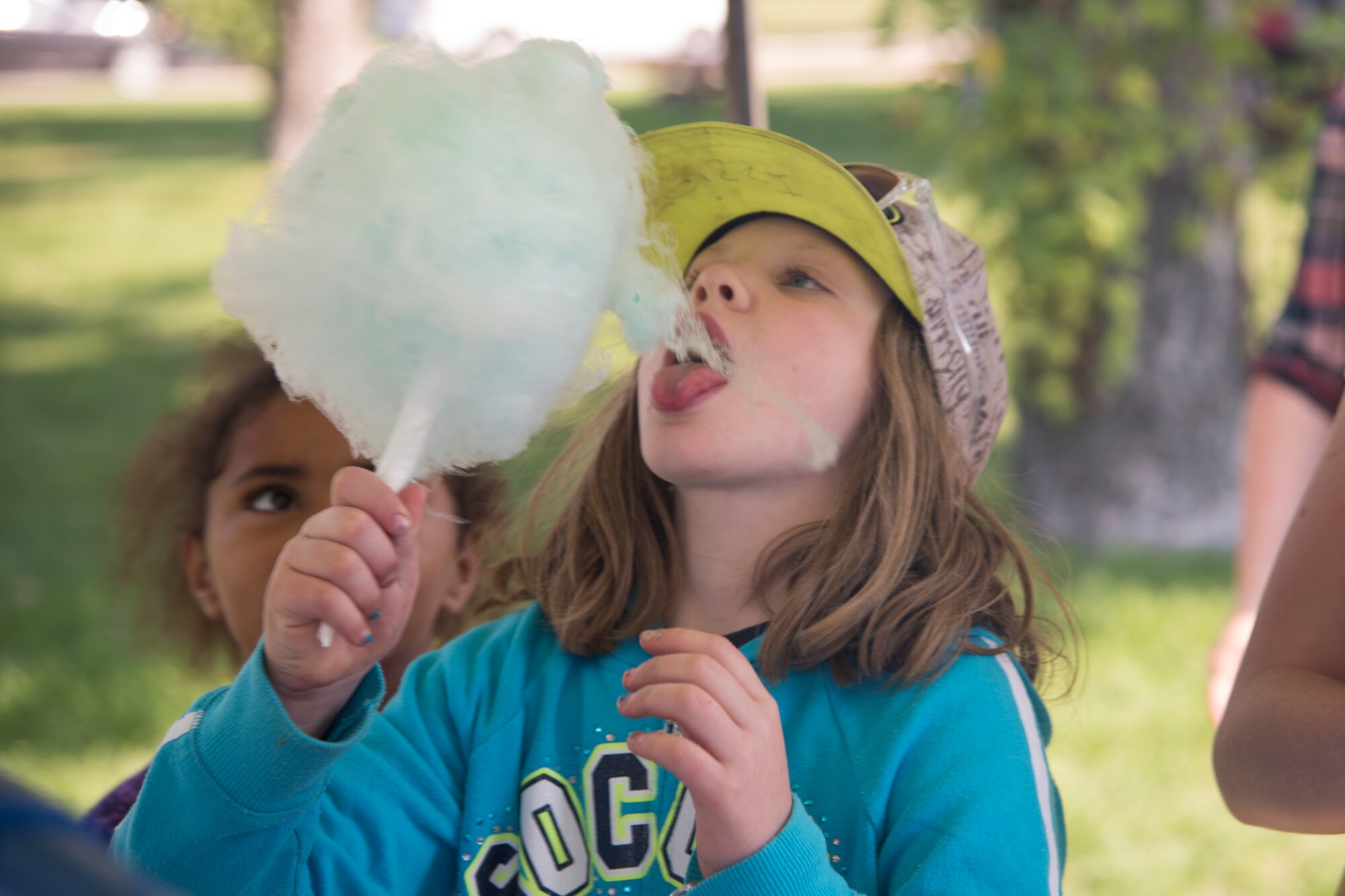 Kids enjoy free cotton candy at the 2018 Fairchild Food Truck Festival, Aug. 28, 2018, at Fairchild Air Force Base, Washington. The base has a decades-long history of offering a yearly picnic for its Airmen, but members of the 92nd Force Support Squadron reached out to the local community to make it better with the first Food Truck Festival in 2016. (U.S. Air Force photo/ Senior Airman Ryan Lackey)