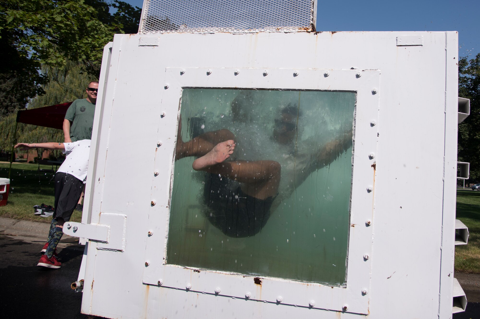 U.S. Air Force 1st Lieutenant Kyle Diaz, 92nd Logistics Readiness Squadron material management flight commander, gets dunked by a festival-goer at the 2018 Fairchild Food Truck Festival, Aug. 28, 2018, at Fairchild Air Force Base, Washington. Base leaders volunteered for the dunk tank attraction to help raise money toward the 2018 Air Force Ball. (U.S. Air Force photo/ Senior Airman Ryan Lackey)