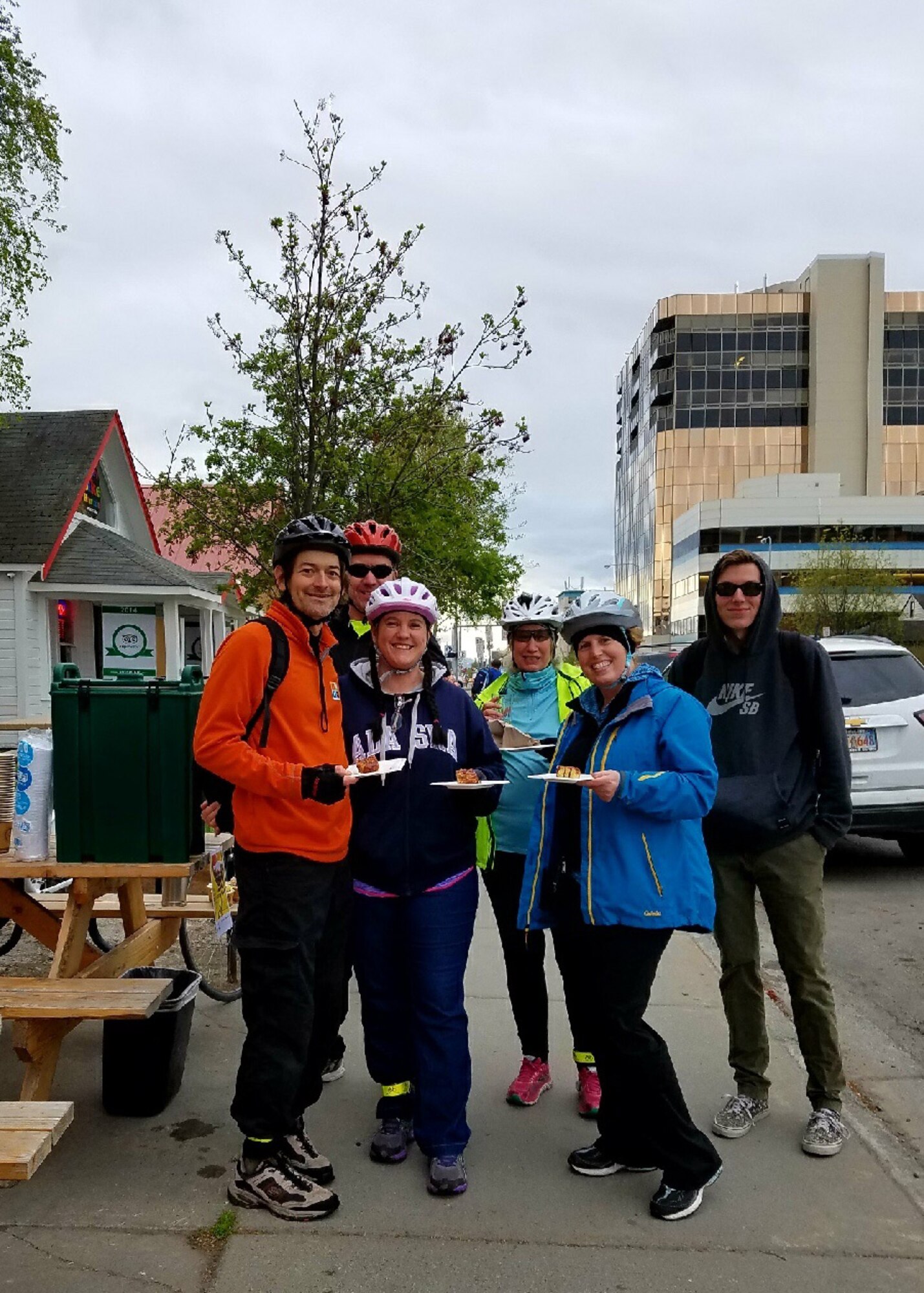 A group of Joint Base Elmendorf-Richardson 673rd Force Support Squadron cyclists receive free sticky pecan rolls from Snow City Café during their Anchorage Bike to Work Day commute in Anchorage, Alaska, May 17, 2017. En route there were designated places to take a break and receive swag and a free breakfast during the Anchorage Bike to Work Day.