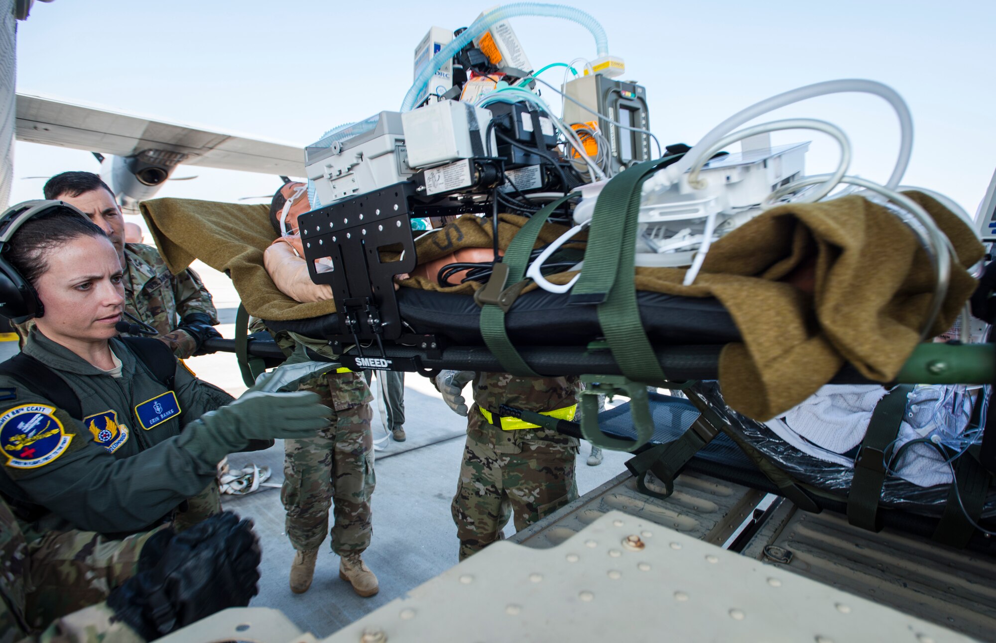 U.S. Air Force Capt. Erin Banks, 88th Medical Group flight nurse, helps lift a simulated patient onto a Humvee during Exercise Ultimate Caduceus 2018 at Travis Air Force Base, California, Aug. 23, 2018. Ultimate Caduceus 2018 is an annual patient movement exercise designed to test the ability of U.S. Transportation Command to provide medical evacuation. (U.S. Air Force photo by Staff Sgt. Daniel Phelps)