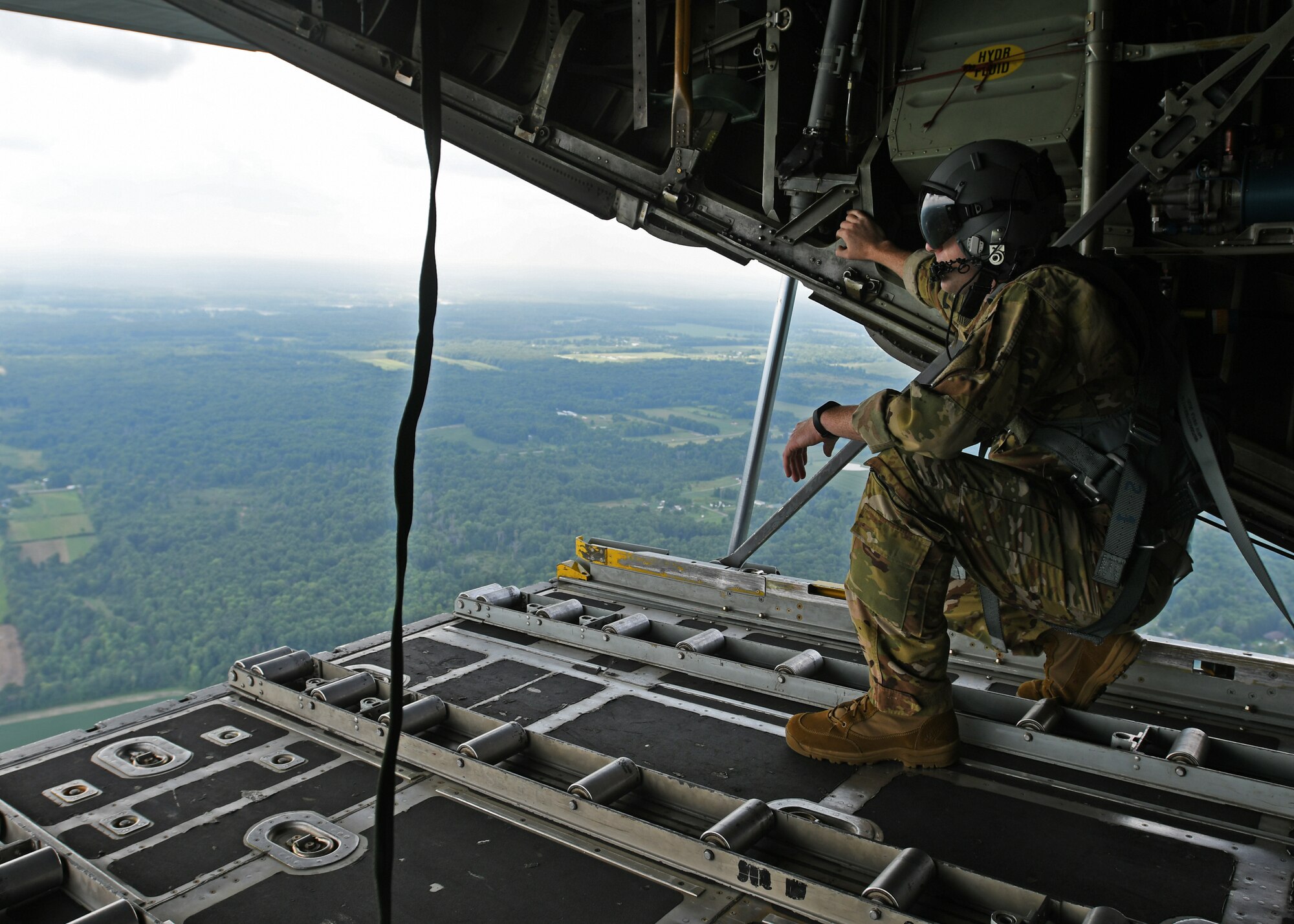 Staff Sgt. Jed Pickett, 700th Aerial Squadron loadmaster, stands on the open ramp of a C-130 Hercules as he simulates an airdrop at Youngstown Air Reserve Station, Ohio, Aug. 10, 2018. Loadmasters are responsible for physically pushing the drops out of the aircraft, as the rest of the crew navigates and directs when to drop. (U.S. Air Force photo by Staff Sgt. Miles Wilson)