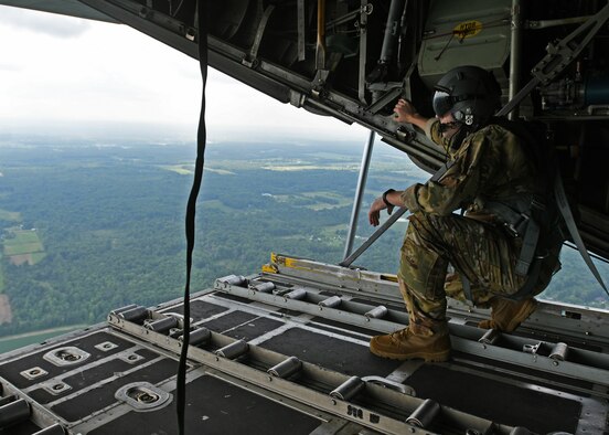 Staff Sgt. Jed Pickett, 700th Aerial Squadron loadmaster, stands on the open ramp of a C-130 Hercules as he simulates an airdrop at Youngstown Air Reserve Station, Ohio, Aug. 10, 2018. Loadmasters are responsible for physically pushing the drops out of the aircraft, as the rest of the crew navigates and directs when to drop. (U.S. Air Force photo by Staff Sgt. Miles Wilson)