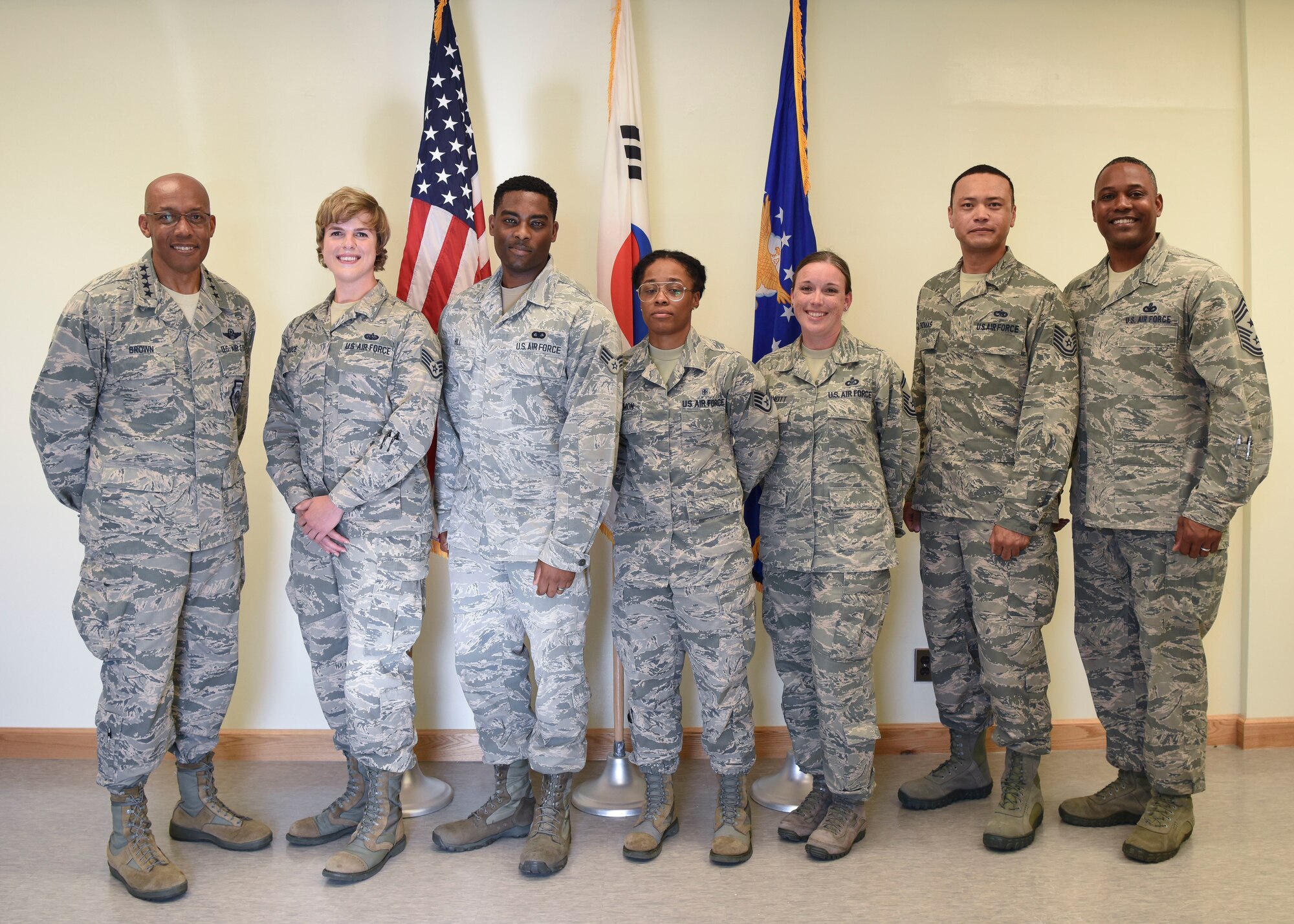 U.S. Air Force Gen. CQ Brown, Jr., Pacific Air Forces commander (left), and Chief Master Sgt. Anthony Johnson, PACAF command chief (far right), pose with 8th Fighter Wing Airmen during an immersion at Kunsan Air Base, Republic of Korea, Aug. 29, 2018. During his visit, Brown recognized these Airmen for their hard work and outstanding performance within their squadrons. (U.S. Air Force photo by Senior Airman Savannah L. Waters)