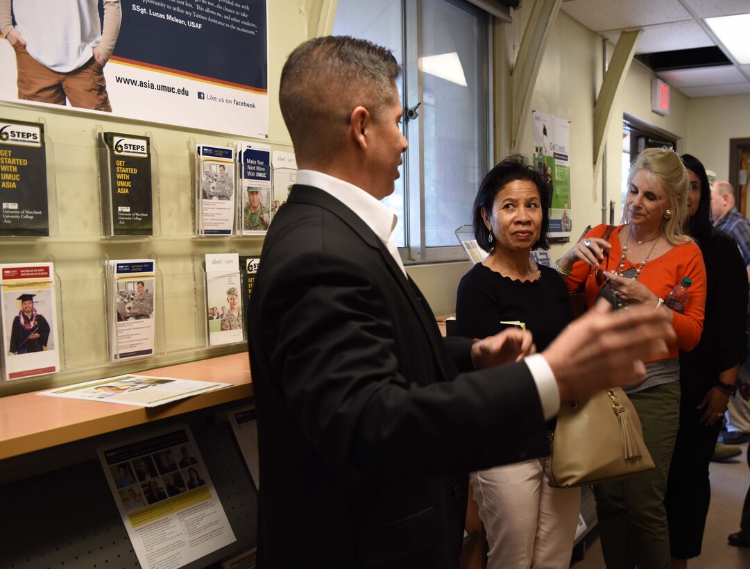 Thomas Fagoso, 8th Force Support Squadron director of education, briefs Sharene Brown, wife of Gen. CQ Brown, Jr., Pacific Air Forces commander (COMPACAF), during a tour of facilities at Kunsan AB, Republic of Korea, Aug. 29, 2018. Kunsan is the second of two Air Force bases on the Korean Peninsula that COMPACAF visited during a four-day immersion in the region. (U.S. Air Force photo by Staff Sgt. Jasmonet D. Jackson)