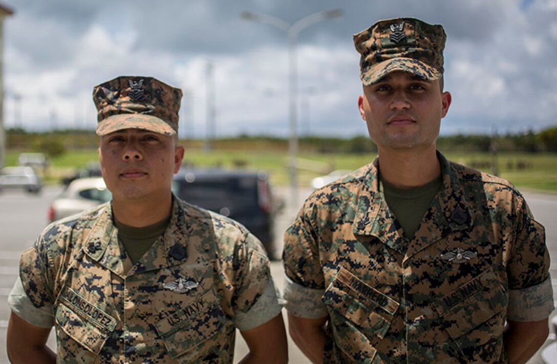 Hospital Corpsmen First Class Jose Marrero Dejesus and Ricardo Alonsolopez, with 2nd Battalion, 3rd Marines, standby before being awarded the Navy and Marine Corps Achievement Medal on Camp Hansen, Okinawa, Japan, July 13, 2018. They were on their way to get breakfast when they noticed a Marine showing signs of distress while running the physical fitness test. Marrero and AlonsoLopez conducted medical care to the distressed Marine which resulted in saving that Marine's life. (U.S. Marine Corps photo by Lance Cpl. Marcus Allen)