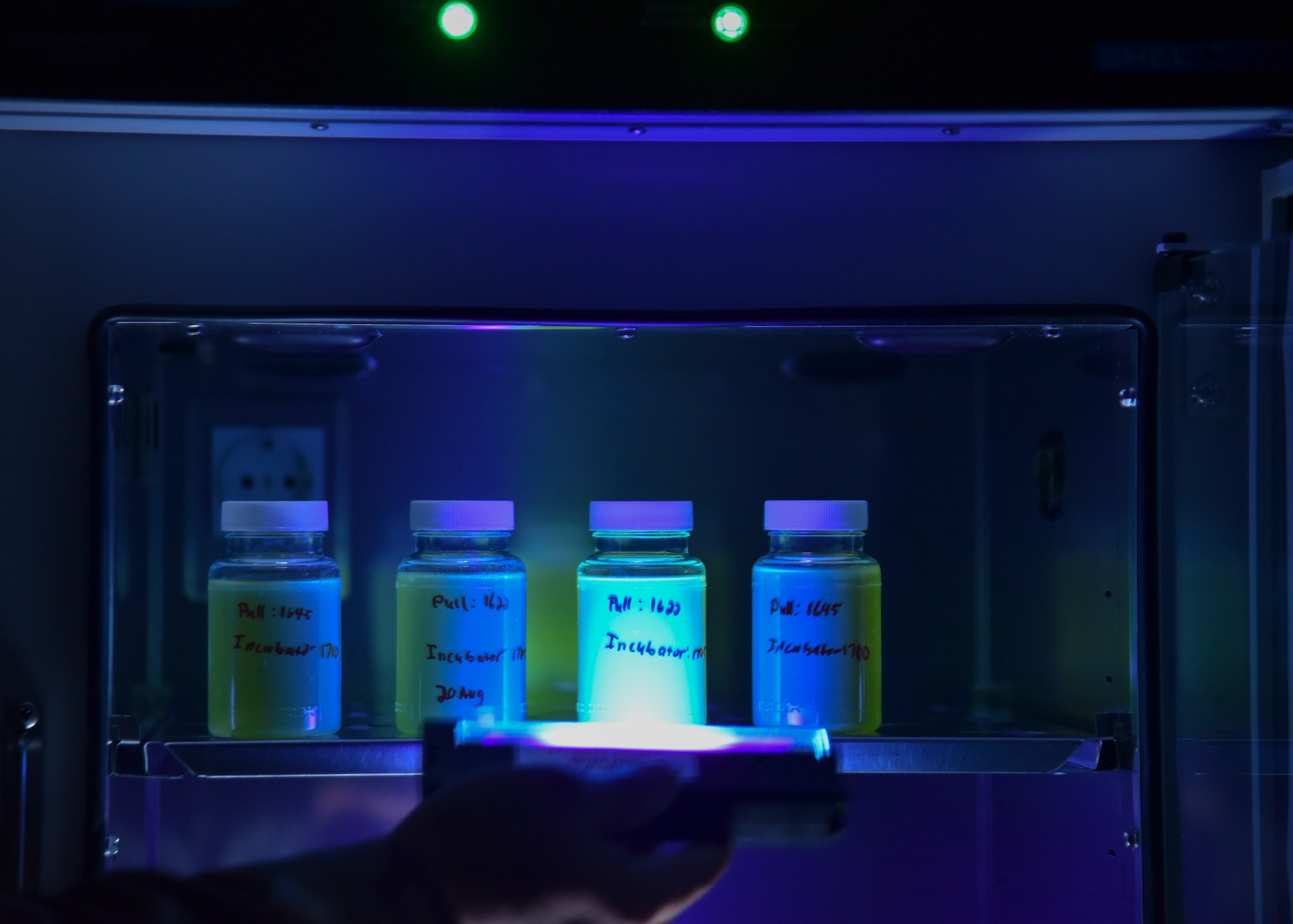 Samples from bottled and municipal water are placed in the incubator for 24 hours before determining if bacteria is present at Al Udeid Air Base, Qatar, August 22, 2018. Both bottled water and municipal water from the tap on base are tested weekly and monthly for bacteria and acidity. (U.S. Air Force photo by Staff. Sgt. Enjoli Saunders)