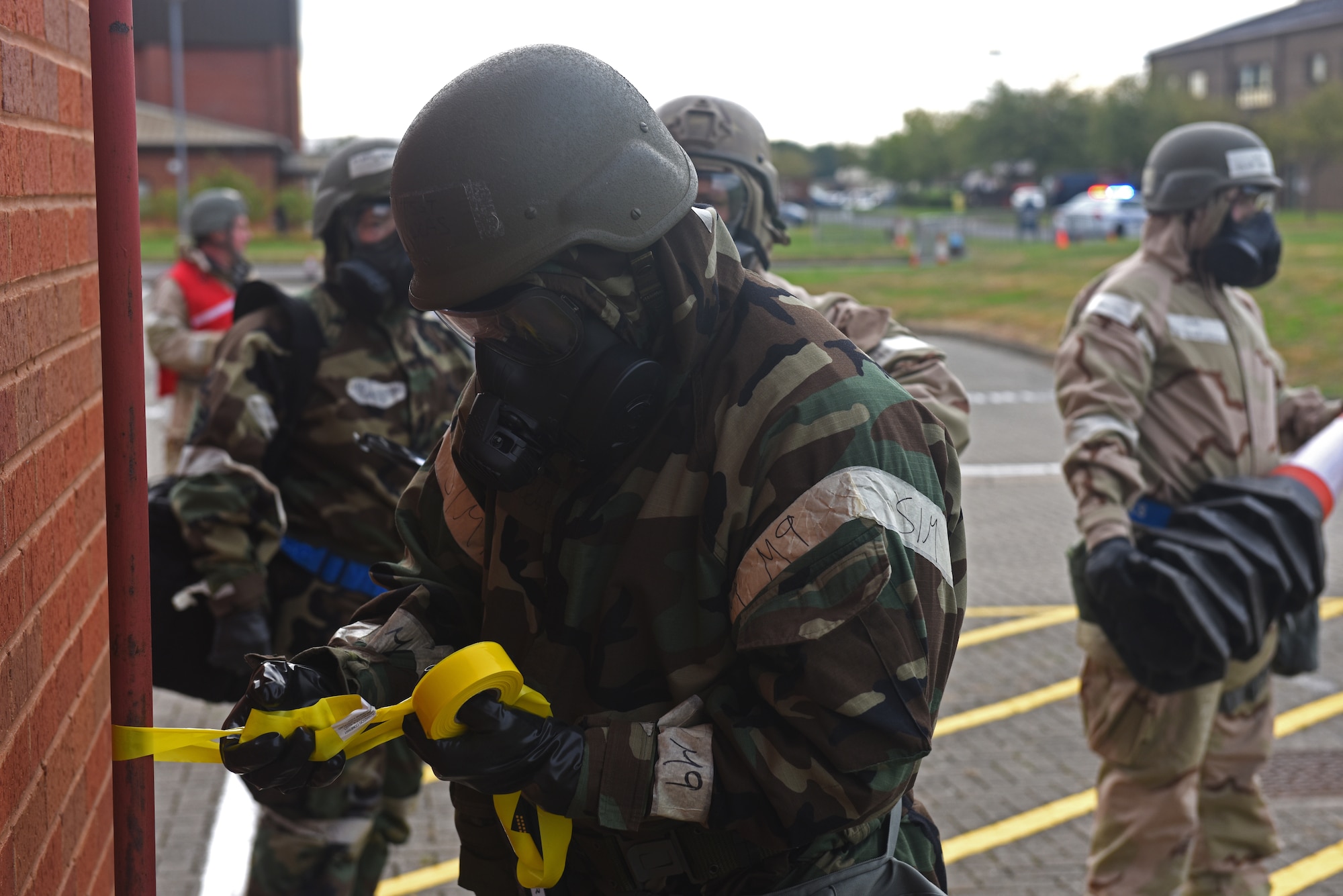 U.S. Air Force Tech. Sgt. Larry Lucas, 100th Operations Support Squadron aircrew flight equipment craftsman, sets up a cordon during a mission assurance exercise at RAF Mildenhall, England, Aug. 28, 2018. The exercise was the first of its kind to feature a drone-related scenario, and also focused on cargo deployment, aircraft generation and intelligence gathering (U.S. Air Force photo by Airman 1st Class Brandon Esau)