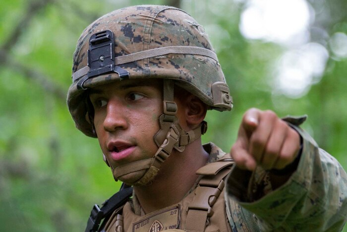 A Marine gives directions to his squad.