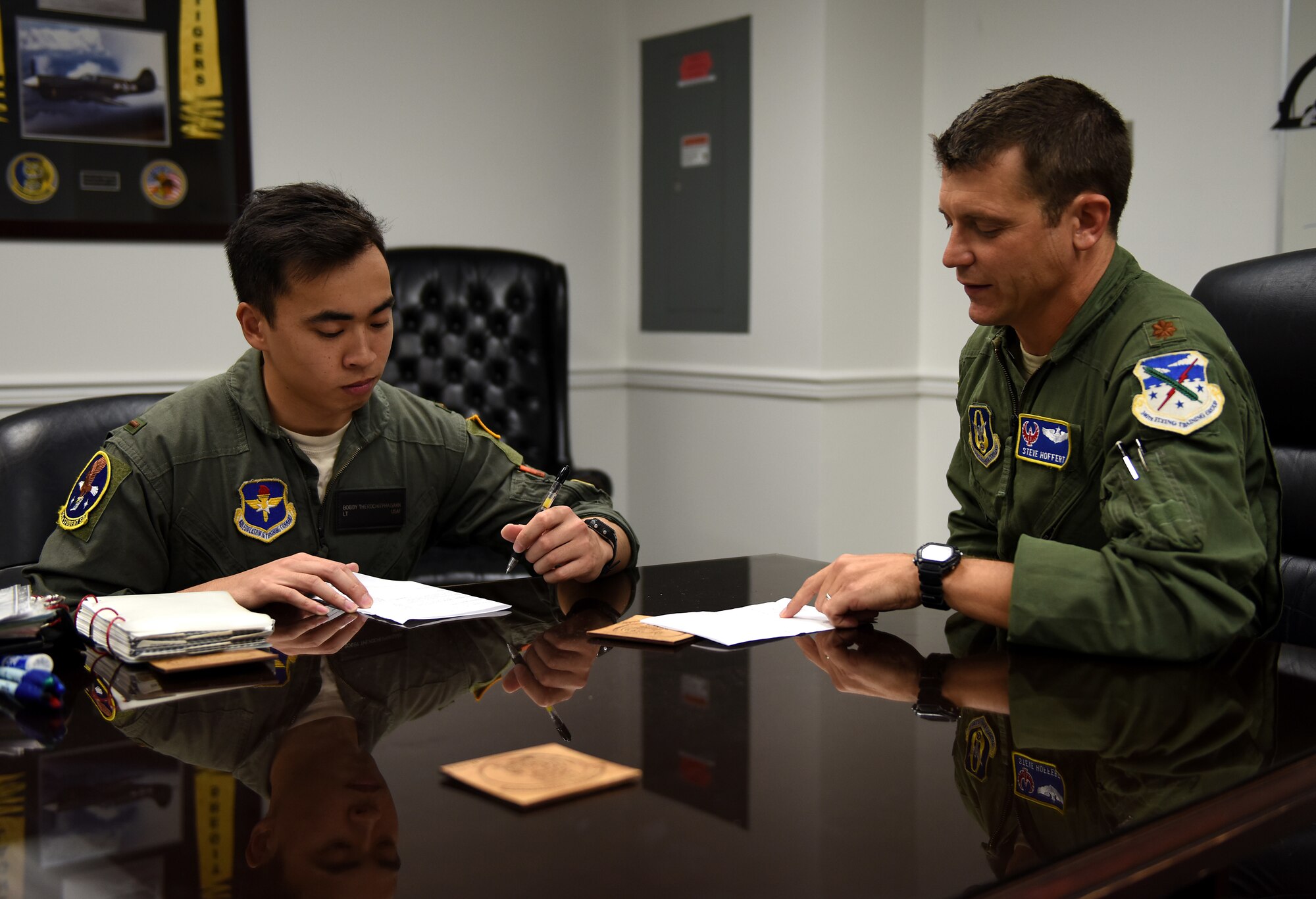 Maj. Stephen Hoffert, 43rd Flying Training Squadron assistant director of operations, debriefs 2nd Lt. Bobby Therdchitphaisarn, 14th Student Squadron student pilot, after their T-6A Texan II training flight Aug. 28, 2018, on Columbus Air Force Base, Mississippi. The 43rd FTS is Columbus AFB’s Total Force component. (U.S. Air Force photo by Airman 1st Class Beaux Hebert)