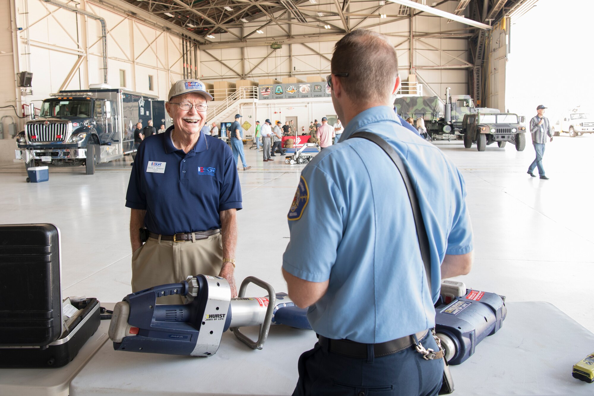 Dave Shearer, Employer Support of the Guard and Reserve volunteer, speaks with a Grissom Air Reserve Base, Ind. firefighter during a tour at of the base Aug. 23, 2018. During the two-day event , Airmen from the 434th ARW teamed up with those from the 122nd Fighter Wing in Fort Wayne, Ind., the 181st intelligence Wing in Terre Haute, Ind., and the Indiana Employer Support of the Guard and Reserve to host a tour and orientation flight for civilian employers. (U.S. Air Force Photo/Tech. Sgt. Benjamin Mota)