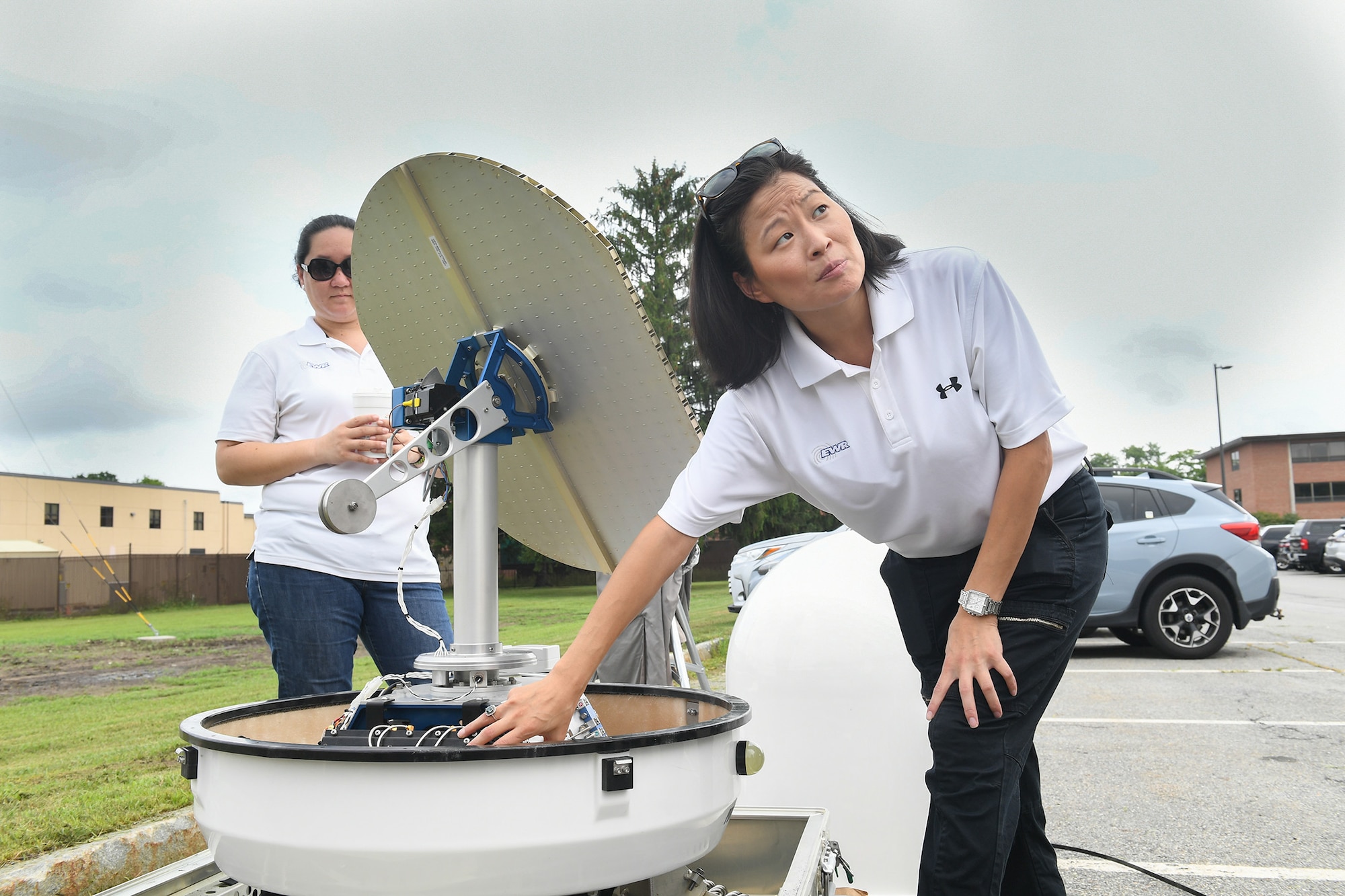 Margaret Williams, right, vice president of EWR Radar Inc., speaks to base personnel about the doppler radar system installed Aug. 14 at the Hanscom Air Force Base, Mass., weather engineering facility while Rebecca Williams, EWR contract administrator, looks on. (U.S. Air Force photo by Todd Maki)