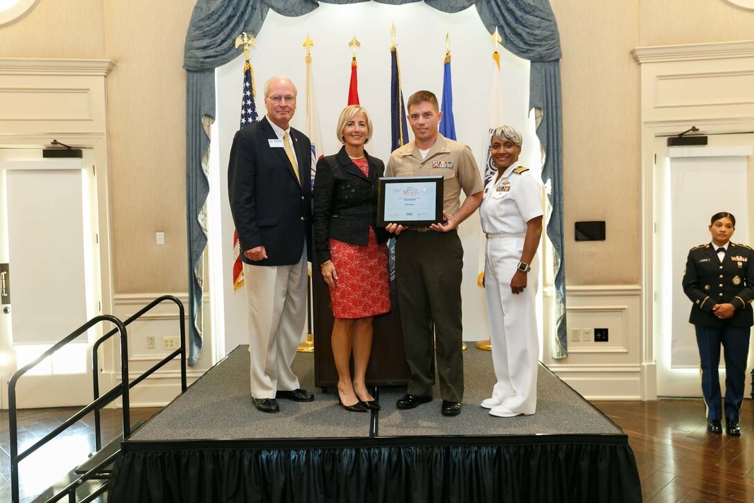 Maj. Samuel Johnson, second from left, executive officer, 3rd Battalion, 14th Marine Regiment, 4th Marine Division, presents the Secretary of Defense Employer Support Freedom Award to his civilian employer Duke Energy at the Pentagon, Aug. 24, 2018. The Freedom award is presented annually to the nation's 15 most supportive employers who have demonstrated exceptional support. It is the highest recognition given by the U.S. government to civilian employers for their support of employees who serve in the Reserve or National Guard. (Courtesy photo)