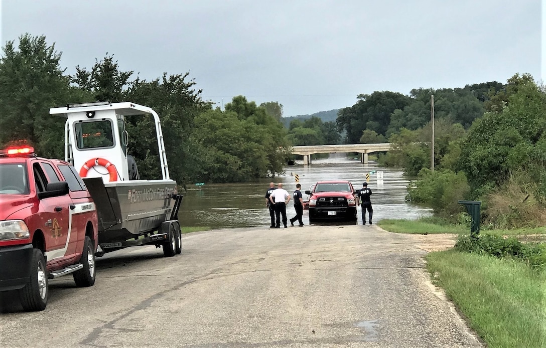 Firefighters prepare to launch a boat for a rescue operation.